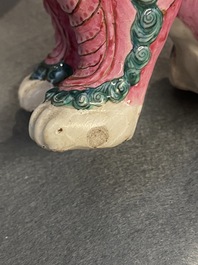 A Chinese famille rose model of a Buddhist lion and a pair of verte biscuit joss stick holders, 19th C.